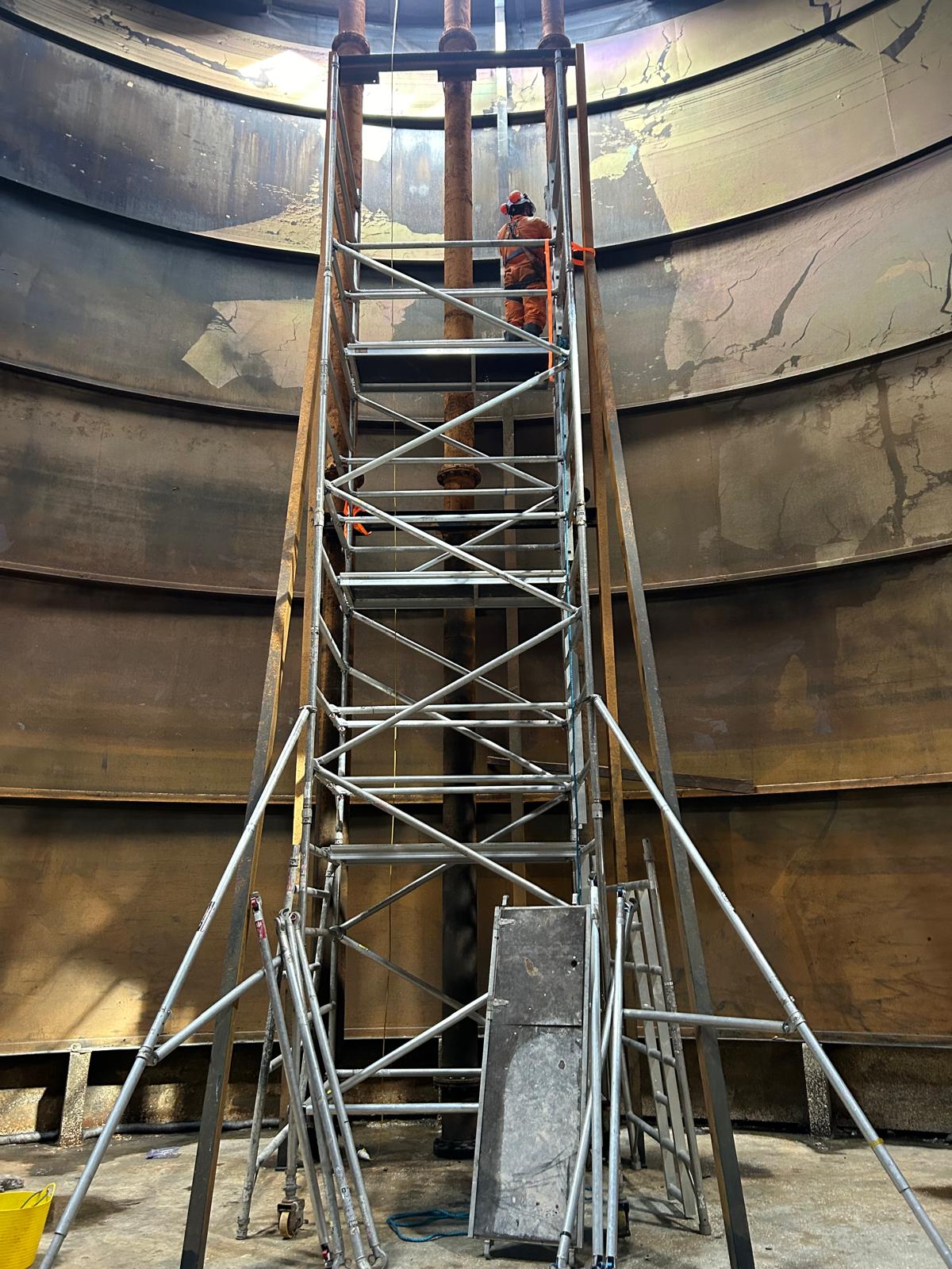 Scaffold tower inside a large steel storage tank for internal inspection and repair
