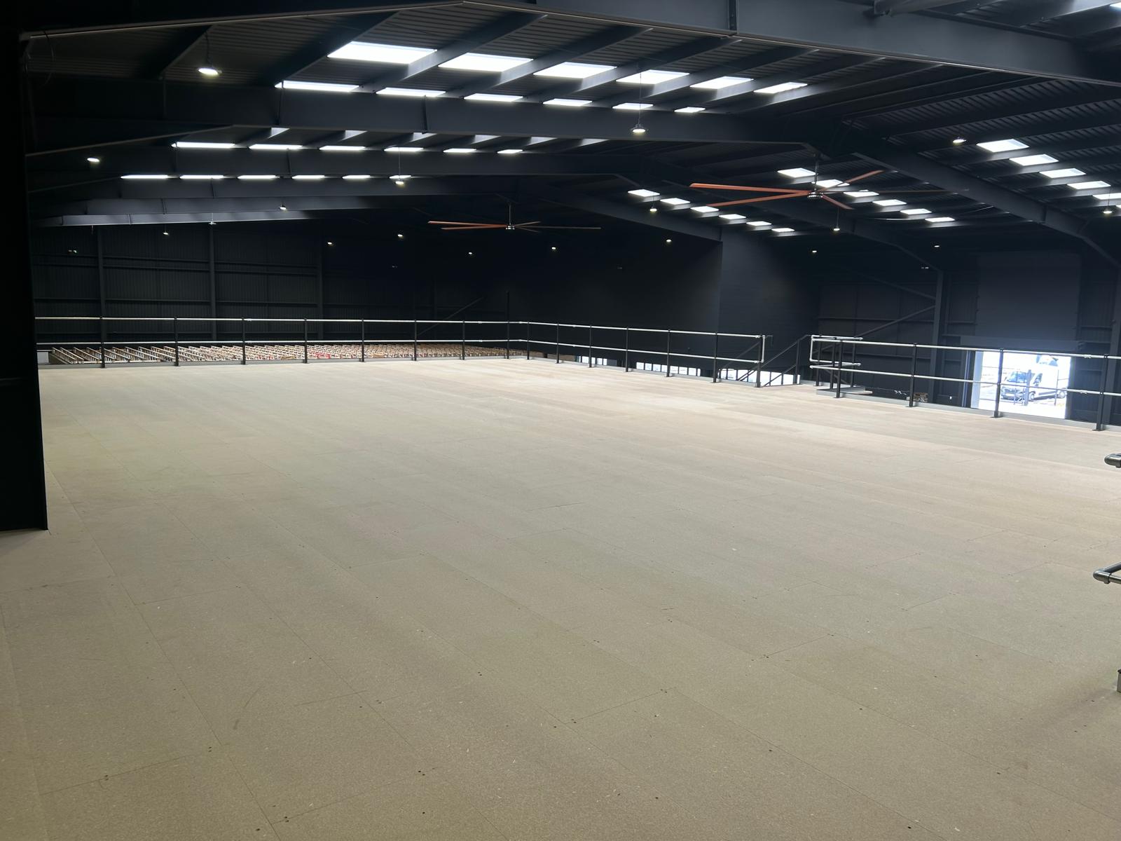 Large completed mezzanine floor with steel handrails inside industrial warehouse